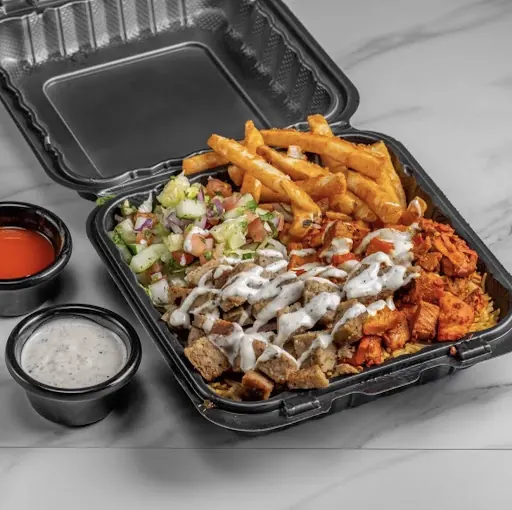 Combo platter with chicken and gyro over rice, fries, salad and sauces