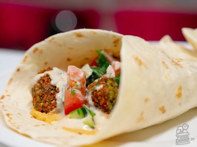 Falafel wrap with hummus, tomato, cucumber and tahini