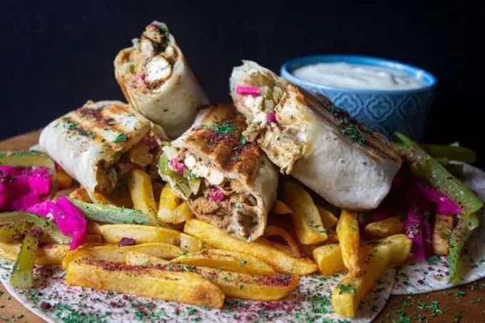 Grilled shawarma wraps with fries, pickles and garlic sauce