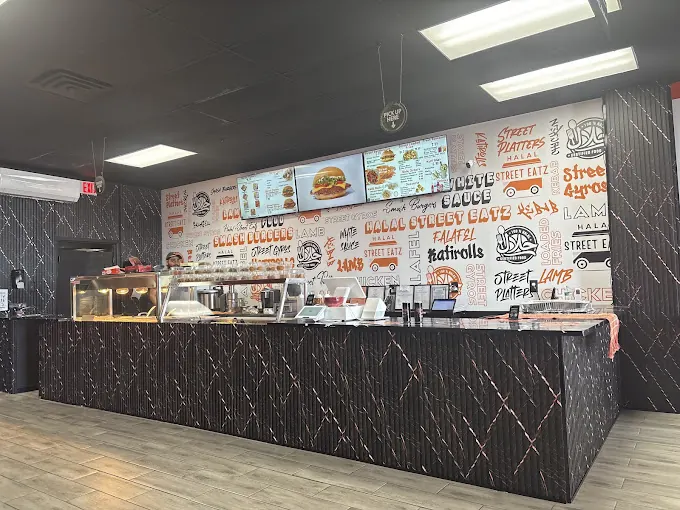 Inside Halal Street Eatz: counter and menu screens