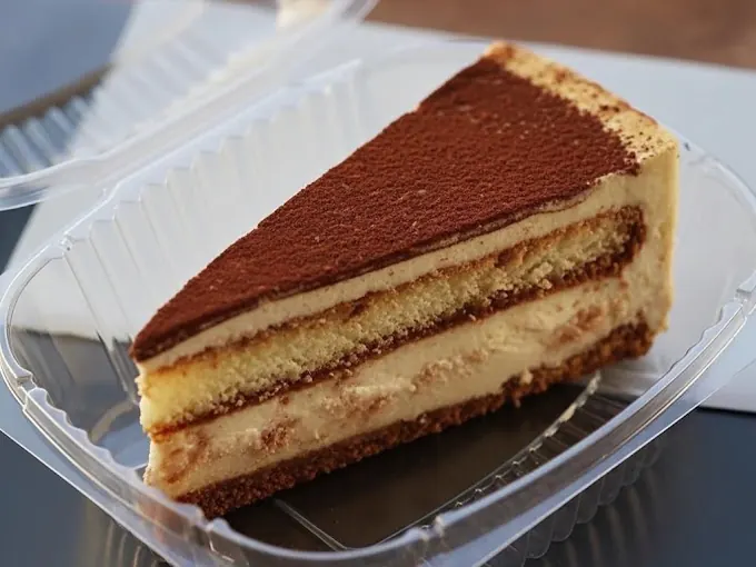 Slice of tiramisu dusted with cocoa