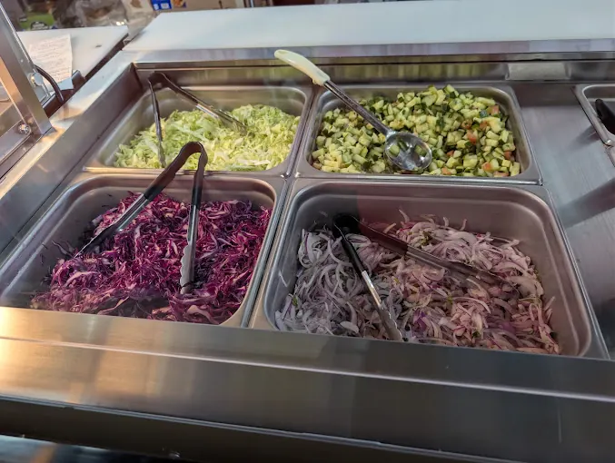 Fresh toppings: shredded lettuce, cucumber salad, red cabbage and onions